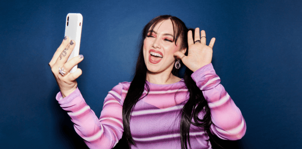 Mujer sonriendo saludando al teléfono